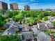 Aerial view of a community showcases mature trees, inviting homes, and proximity to nearby city at 84 Mount Vernon Cir, Atlanta, GA 30338