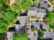 An aerial view of townhomes showing parking and mature trees at 84 Mount Vernon Cir, Atlanta, GA 30338