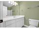 Bathroom with white vanity, white cabinets, white toilet, and green walls at 84 Mount Vernon Cir, Atlanta, GA 30338