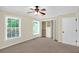 Spacious bedroom featuring neutral walls, carpet, ceiling fan, and natural light at 84 Mount Vernon Cir, Atlanta, GA 30338