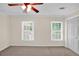 Bedroom with two windows and neutral walls, carpet, and a closet at 84 Mount Vernon Cir, Atlanta, GA 30338