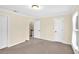 Neutral bedroom showing doors to hallway, closet, and attic; neutral carpet and paint at 84 Mount Vernon Cir, Atlanta, GA 30338