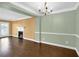 Elegant dining room features hardwood floors, a chandelier, and wainscoting at 84 Mount Vernon Cir, Atlanta, GA 30338