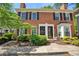Charming brick townhome with black shutters, a bay window, and a well-manicured front yard at 84 Mount Vernon Cir, Atlanta, GA 30338