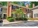 Charming brick townhouse with black shutters, manicured landscaping, and a well-maintained front yard at 84 Mount Vernon Cir, Atlanta, GA 30338