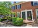 A well-maintained brick townhome with black shutters, a tidy front garden, and a welcoming entrance at 84 Mount Vernon Cir, Atlanta, GA 30338