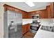 Updated kitchen featuring stainless steel appliances, wood cabinets, and stone countertops at 84 Mount Vernon Cir, Atlanta, GA 30338