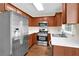Modern kitchen with stainless steel appliances, wooden cabinets, and light countertops at 84 Mount Vernon Cir, Atlanta, GA 30338