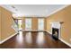 Open-concept living area with hardwood floors, a fireplace, and large windows offering plenty of light at 84 Mount Vernon Cir, Atlanta, GA 30338