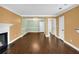 Spacious living and dining area with hardwood floors, fireplace, elegant chandelier, and neutral paint at 84 Mount Vernon Cir, Atlanta, GA 30338