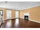 Bright living room boasts hardwood floors, a fireplace, and abundant natural light from large windows at 84 Mount Vernon Cir, Atlanta, GA 30338