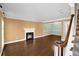 Inviting living room featuring hardwood floors, fireplace, staircase, and neutral paint colors at 84 Mount Vernon Cir, Atlanta, GA 30338
