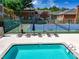 Refreshing swimming pool with comfortable lounge chairs and a tennis court in a private community setting at 84 Mount Vernon Cir, Atlanta, GA 30338