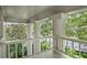 Inviting balcony with white columns and railings, surrounded by lush greenery at 908 N Highland Ne Ave, Atlanta, GA 30306
