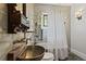 Bathroom featuring stylish vessel sink, mirrored tile, and shower/tub combo with curtain at 908 N Highland Ne Ave, Atlanta, GA 30306