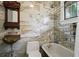 Bathroom featuring stylish vessel sink, marble tile, and shower/tub combo with curtain at 908 N Highland Ne Ave, Atlanta, GA 30306