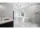 Elegant bathroom featuring marble walls, freestanding tub, and glass-enclosed shower at 908 N Highland Ne Ave, Atlanta, GA 30306