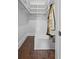 Walk-in closet with custom shelving, a bench, and hardwood flooring at 908 N Highland Ne Ave, Atlanta, GA 30306