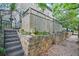 Landscaped exterior with a stone retaining wall and staircase at 908 N Highland Ne Ave, Atlanta, GA 30306