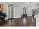 Grand foyer featuring rich hardwood floors, decorative doors, and elegant trim, leading to staircase at 908 N Highland Ne Ave, Atlanta, GA 30306