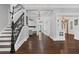 Grand foyer with detailed staircase, hardwood floors, and elegant lighting at 908 N Highland Ne Ave, Atlanta, GA 30306