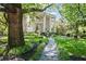 Traditional home with manicured front yard, walkway, and mature landscaping at 908 N Highland Ne Ave, Atlanta, GA 30306