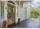 Classic front porch with lion statues, a wooden door, and beautiful architectural details at 908 N Highland Ne Ave, Atlanta, GA 30306