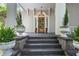 Inviting front porch featuring decorative planters and a classic front door at 908 N Highland Ne Ave, Atlanta, GA 30306