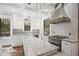 Well-lit kitchen featuring marble countertops, stainless steel appliances, and white subway tile backsplash at 908 N Highland Ne Ave, Atlanta, GA 30306