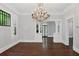 Well-lit living room featuring a chandelier, hardwood floors, and elegant architectural details at 908 N Highland Ne Ave, Atlanta, GA 30306