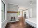 Bright living room with hardwood floors, stone fireplace, and large windows at 908 N Highland Ne Ave, Atlanta, GA 30306