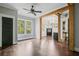 Open-concept living room featuring wood beams and adjacent bath at 908 N Highland Ne Ave, Atlanta, GA 30306