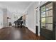 Elegant living room with dark hardwood floors, a black grand piano, fireplace, and ample natural light through large windows at 908 N Highland Ne Ave, Atlanta, GA 30306