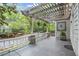 Comfortable side porch area with pergola, white railing, and stone columns at 908 N Highland Ne Ave, Atlanta, GA 30306