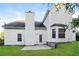 Home's backyard featuring green grass, a concrete patio, and white siding at 137 Legend Creek Dr, Canton, GA 30114