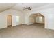 Large bonus room boasts carpeting, ceiling fan, and plenty of natural light at 137 Legend Creek Dr, Canton, GA 30114