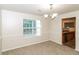 Dining room with neutral carpet, large window, and an elegant light fixture at 137 Legend Creek Dr, Canton, GA 30114
