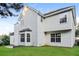Two-story home with white siding, a well-maintained lawn, and a black roof at 137 Legend Creek Dr, Canton, GA 30114