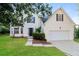 Charming two-story home featuring a well-manicured lawn and a two-car garage, creating an inviting curb appeal at 137 Legend Creek Dr, Canton, GA 30114