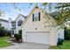 Spacious two car garage with driveway and partial view of the home's exterior at 137 Legend Creek Dr, Canton, GA 30114