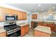 Modern kitchen featuring stainless steel appliances, granite countertops, and wood cabinets at 137 Legend Creek Dr, Canton, GA 30114