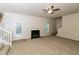 Spacious living room with a fireplace, stairs and view into the kitchen at 137 Legend Creek Dr, Canton, GA 30114