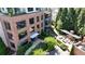 Aerial view of a brick building with outdoor living spaces, including a pergola and patio at 214 Vickery Falls Dr, Roswell, GA 30075