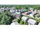 Aerial view featuring a brick building nestled in a community with diverse housing amidst green spaces at 214 Vickery Falls Dr, Roswell, GA 30075