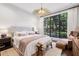 Bedroom with a large picture window and a tufted headboard on the bed at 214 Vickery Falls Dr, Roswell, GA 30075