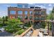 Brick building with balconies and a patio featuring an outdoor kitchen and seating area at 214 Vickery Falls Dr, Roswell, GA 30075