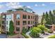 Beautiful brick building with balconies, large windows, manicured lawns and gardens at 214 Vickery Falls Dr, Roswell, GA 30075
