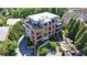 Stunning brick building with rooftop terraces, surrounded by lush greenery and a charming neighborhood at 214 Vickery Falls Dr, Roswell, GA 30075