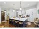 Bright kitchen featuring a large center island with bar stool seating and stainless steel appliances at 214 Vickery Falls Dr, Roswell, GA 30075