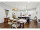 Modern kitchen featuring a large island with seating, stylish pendant lights, and hardwood floors at 214 Vickery Falls Dr, Roswell, GA 30075
